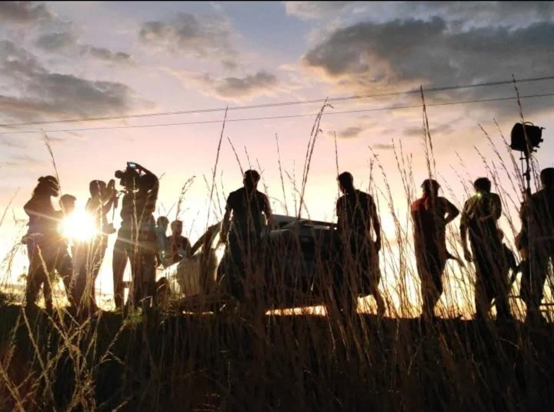 movie crew in the paddy field during filming